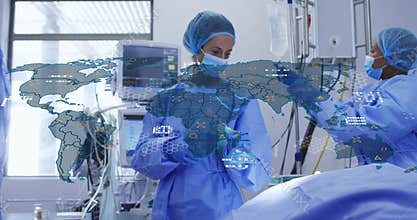 doctor adjusting monitor and initiating global health map while nurses assembling anesthesia mask