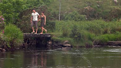 Couple walking past a beautiful lake in the countryside