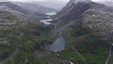 Scenic alpine valley with multiple lakes connected by rivers surrounded by rugged mountain terrain