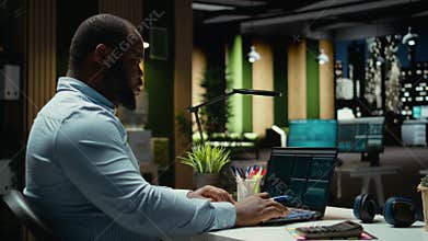 Black consultant reviewing data insights and managing agenda on laptop