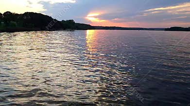 A beautiful reflection of the sunset on the calm surface of the river water