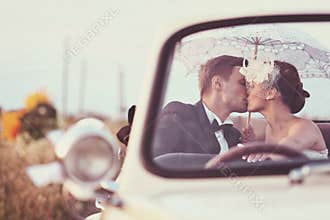 Bride and groom in a vintage car