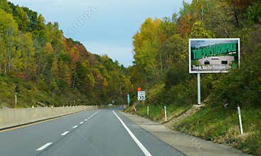Clark Summit, Pennsylvania, U.S.A - Oct 18, 2025 - Roadside billboard wishing safe travels from the PA Turnpike, set against a