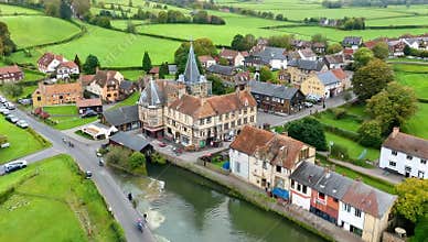 Aerial view of a quaint european village with historic buildings and lush green countryside