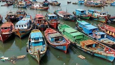Colorful fishing boats docked in a harbor create a vibrant scene of maritime activity today