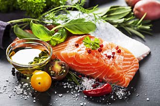 Delicious portion of fresh salmon fillet with aromatic herbs,