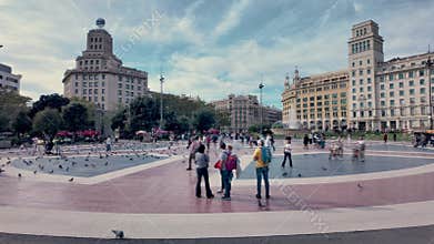 Barcelona, Spain. November 1, 2025, People and pigeons walking at Plaza Catalunya in Barcelona, Spain