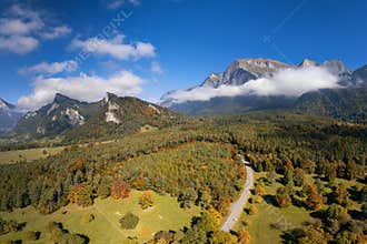view of the St. Luzisteig mountain pass road leading through autumn color forest
