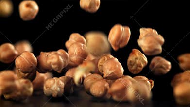 Chickpeas fall on the table. Filmed on a high-speed camera at 1000 fps.