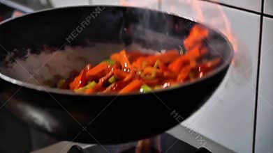 Dynamic Flambé Stir Frying Vegetables in a Professional Kitchen