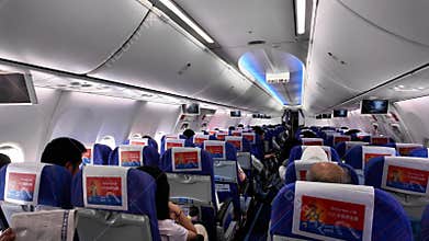 Urumqi, China. July 23, 2025. Passengers sitting in the cabin of a South China Airlines plane are preparing for takeoff