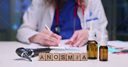 Word Anosmia on wooden blocks by otoscope and nasal drops