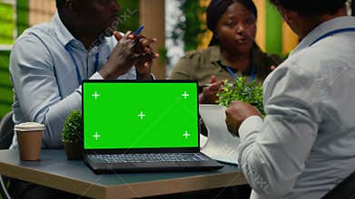 Green screen laptop used by tech startup office programmers doing meeting