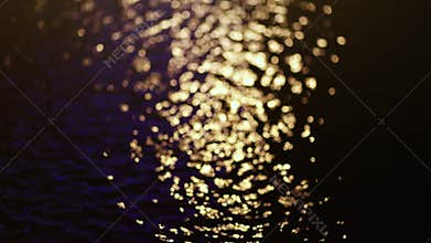 Golden bokeh shimmering on water surface at night, creating a warm and romantic atmosphere, calm emotional scenes, Perfect for