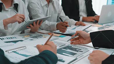 Business Team Collaborating on Financial Analysis with Charts and Reports in Modern Office Setting SACTR