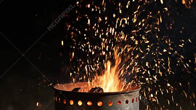 Erupting embers dancing in the night sky during a captivating outdoor fire gathering Generative AI