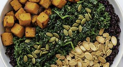 Overhead View of Healthy Vegan Buddha Bowl with Roasted Sweet Potato Kale and Seeds