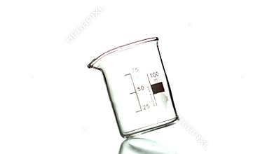 Empty beaker spinning on white background