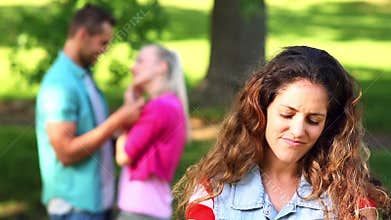 Upset girl watching her crush flirt with another girl