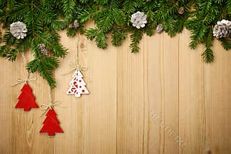 Christmas background with firtree, decorative trees and cones on