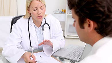 Doctor giving a prescription to her patient