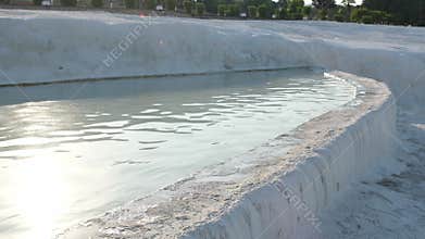 Explore Pamukkales Travertine Pools and Hot Springs During Sunset With People Enjoying the Warm Water and Unique