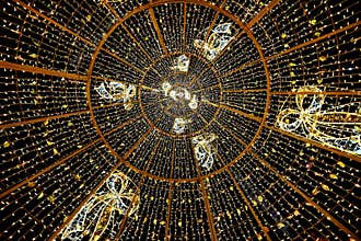 Golden light dome with holiday decorations at night ,December 25, 2025