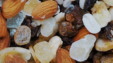 Top view of a nutritious mix with cashews, almonds, and raisins rotating. Ideal