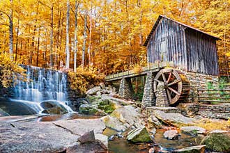 Fall or Autumn image of historic mill and waterfall