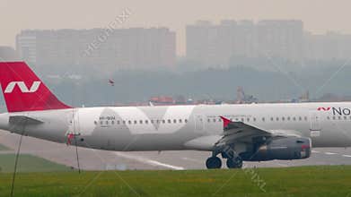 Airbus A321 of Nordwind Airlines taxiing, side view