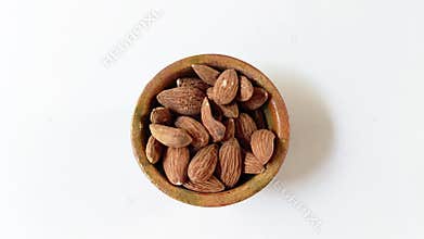 Almonds in Guatemalan clay bowl isolated on white background