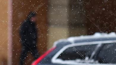 Details of actual snow falling at daytime in European city complicated life