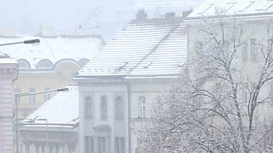 Details of actual snow falling at daytime in European city complicated life
