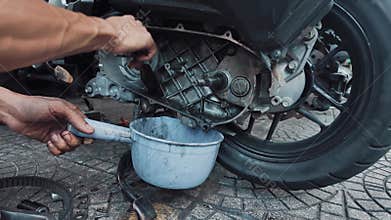 worker performs maintenance at vehicle repair station, man cleanse motorcycle or scooter variator automatic gearbox