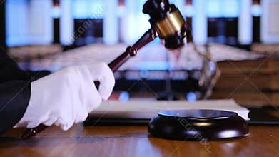 American judge striking gavel in courtroom
