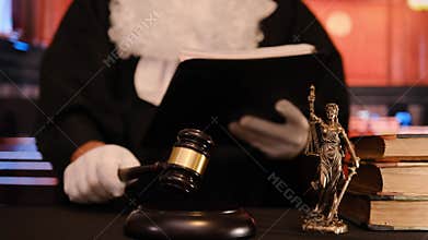 Judge striking gavel pronouncing sentence in courtroom