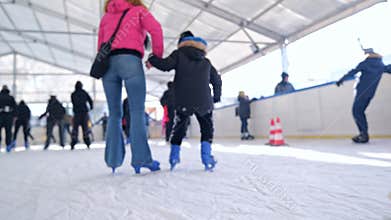 Families With Children Skating On Ice Rink