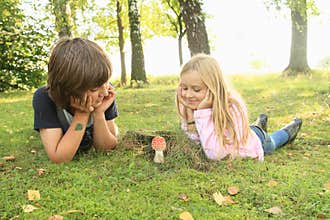 Two kids watching red toadstool