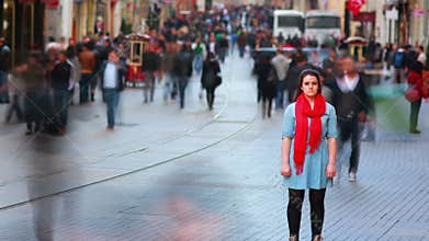Young woman posing, busy street, people walking around, HD
