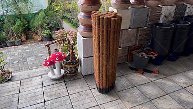 Coir Moss Poles and Garden Pots Display at Outdoor Nursery Shop