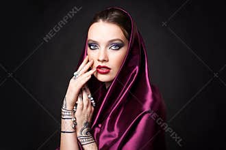 Beautiful woman in oriental style with mehendi in hijab