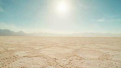 Vast salt flat under bright desert sky