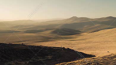 Desert hills bathed in golden sunset light