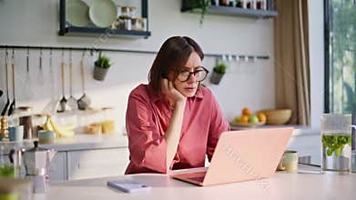 Thoughtful author texting computer writing ideas kitchen closeup. Woman studying