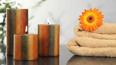 Close up on candles, towels and sunflower