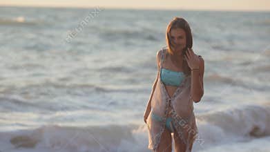 Happy girl runs along the beach and enjoys