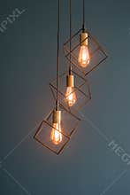 Elegant hanging light fixtures in geometric designs enhancing the ambiance of a modern interior space