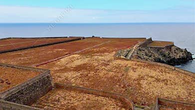 A beautiful scenic coastal landscape featuring historical fortifications along the shores