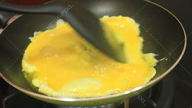 Cooking Scrambled Eggs or Omelette in a Frying Pan with a Spatula