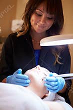 Woman Having Dermo Abrasion Cosmetic Treatment At Spa